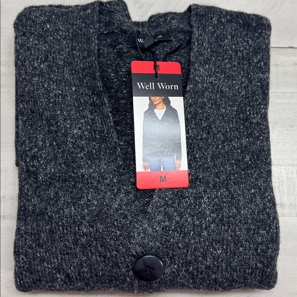 Well worn V-neck Front patch pockets Button front closure Soft yarn sweater